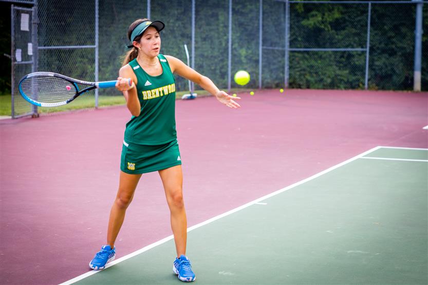 A tennis player serves the ball
